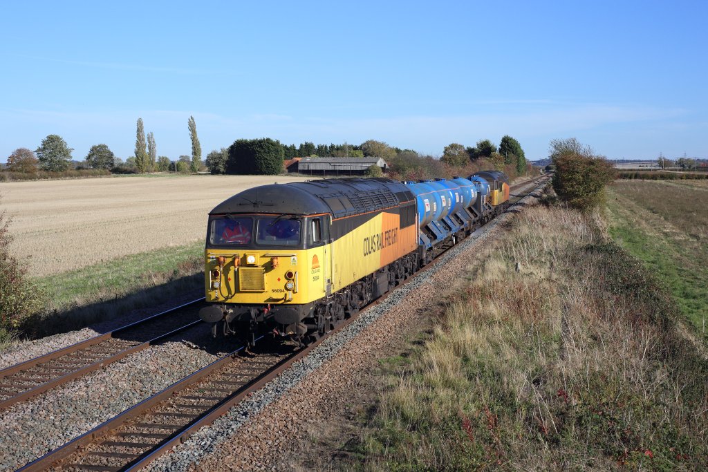 56094 passes Muston (near Bottesford) on 9th October 2018, working the 3J89 0500 Stapleford & Sandiacre - Toton TMD Rail Head Treatment Train. 56090 was bringing up the rear. Although utilising Colas traction and drivers, this particular diagram is actually a DB Cargo working, with the motive power and crews merely hired in. Photo copyright: Ben Wheeler.